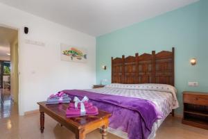 a bedroom with a large bed with pink shoes on a table at Oasis Bahia Fronte Piscine in Corralejo +20 photos