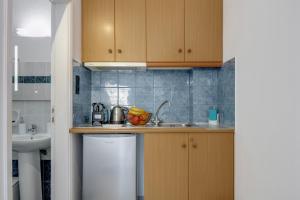 a small kitchen with a sink and a dishwasher at 08 Double room Perivolos beach in Santorini