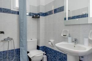 a bathroom with a toilet and a sink at 08 Double room Perivolos beach in Santorini