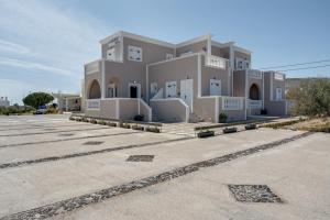 a large building in a parking lot at 08 Double room Perivolos beach in Santorini
