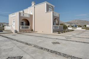a large white building with a lot of stairs at 08 Double room Perivolos beach in Santorini +12 photos