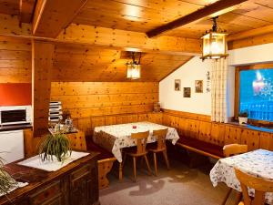 a dining room with a table and chairs at Residence Zirmer Wohnung Erde in Castelrotto +25 photos
