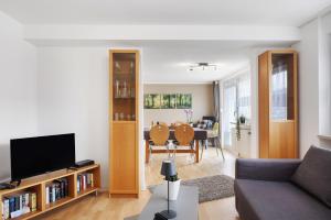 a living room with a couch and a tv at Ferienwohnung Windradblick in Schonach