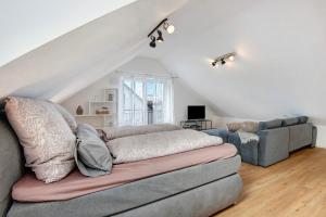 a living room with a couch and a chair at Dachstudio am Donau Rad Weg in Tegernheim