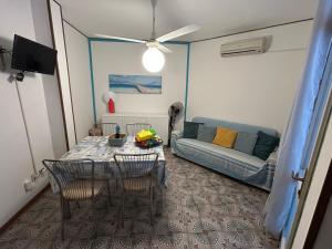 a living room with a table and a couch at Villaggio Olimpia in Bibione