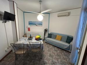 a living room with a table and a couch at Villaggio Olimpia in Bibione
