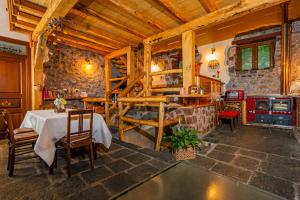 a kitchen with a table and chairs in a room at Bosco Magaudo - Casa U Parmento in Linguaglossa