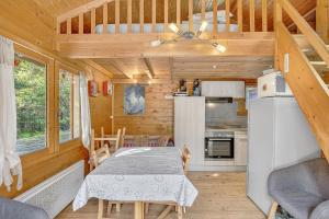 a kitchen with a table in a tiny house at Chalet Le Mazet in Les Prats +15 photos