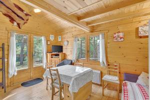 a dining room with a table and chairs in a cabin at Chalet Le Mazet in Les Prats
