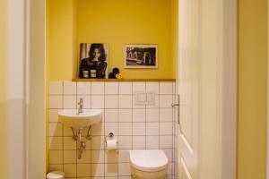 a bathroom with a toilet and a sink at Ferienhaus Monteverde in Meddersheim