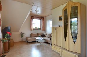 a living room with a couch and a table at Ferienwohnung Nationalparkblick in Altenlotheim