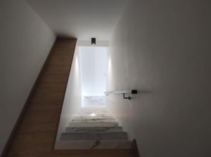 a stairway with a white wall and a stair case at Casa da Mina in Mina do Bugalho +10 photos