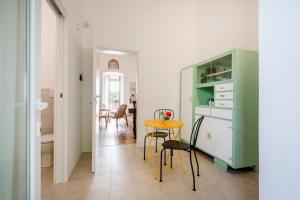 a kitchen and dining room with a table and chairs at Maison Valentina in Monopoli