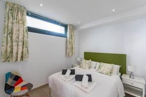 a bedroom with two beds and a window at Spacious apartment in Cómpeta in Cómpeta +6 photos