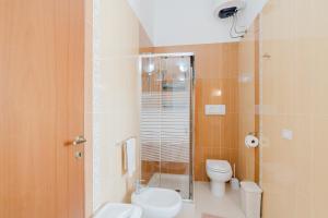a bathroom with a toilet and a glass shower at Villetta Marettimo Cornino in Custonaci +18 photos