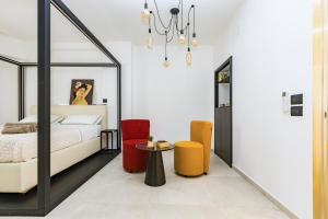a bedroom with a bed and a table and chairs at Gatto Matto in Brolo
