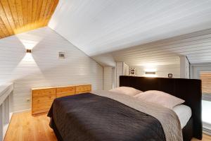 a bedroom with a large bed in a room at Schwarzwaldtraum in Sasbachwalden +19 photos