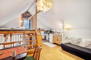 a living room with a bunk bed and a kitchen at Tiny House an der Werra in Bad Sooden-Allendorf