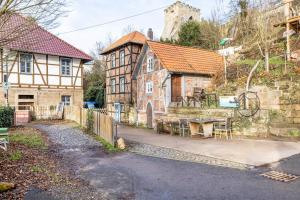 an old building with a table in front of it at Tiny House an der Werra in Bad Sooden-Allendorf