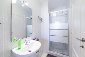 a white bathroom with a sink and a shower at Casa Minuni in Almería +24 photos