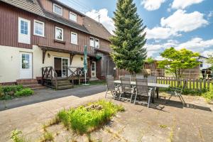 a table and chairs in front of a house at Ferienhaus St Georg Stube in Grömbach