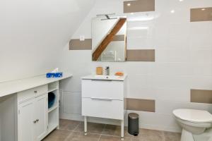 a white bathroom with a toilet and a sink at Martin - Appartement Le Croisic in Le Croisic +18 photos