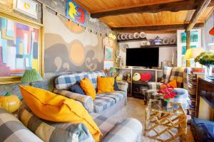 a living room with couches and a flat screen tv at Casa do Campo Dornes Dois in Paio Mendes