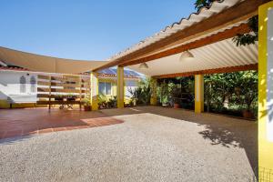 an outdoor patio with awning on a house at Casa do Campo Dornes Dois in Paio Mendes
