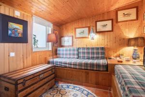 a room with a bed and a bench in a cabin at Casa do Campo Dornes Dois in Paio Mendes +22 photos