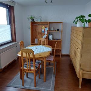 a dining room with a table and chairs at Ferienhaus Hadler in Kaiser Wilhelm Koog