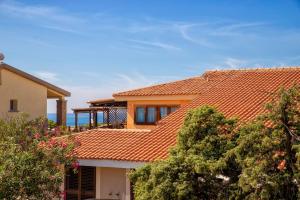 a house with an orange tile roof at Baia delle mimose vista mare in Badesi