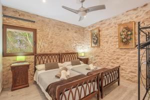 a bedroom with two beds and a ceiling fan at Can Garraseca in Llucmajor +19 photos