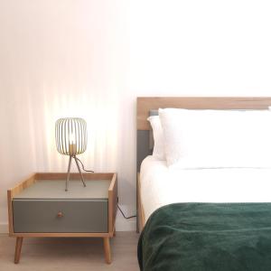 a bedroom with a bed and a nightstand next to a bed at Casa dos Avós in Cascais