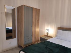 a bedroom with a bed and a dresser with a mirror at Casa dos Avós in Cascais
