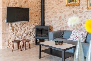 a living room with a couch and a fireplace at Can Garraseca in Llucmajor