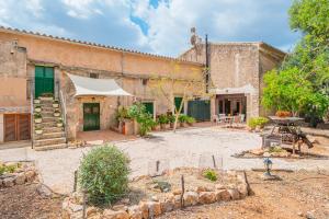 an outdoor patio with a tent in front of a building at Can Garraseca in Llucmajor