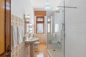 a bathroom with a toilet sink and a shower at Appartamento il Sentiero degli Dei in Agerola +15 photos