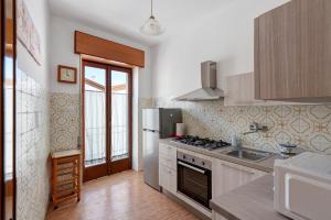 a kitchen with a refrigerator and a sink at Appartamento il Sentiero degli Dei in Agerola