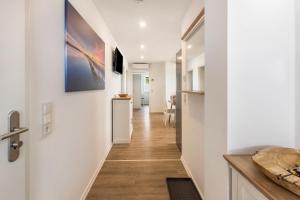 a hallway of a home with white walls and wooden floors at Fewo Landblick Geiseltal in Braunsbedra