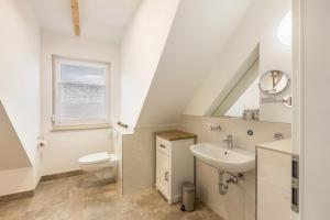 a bathroom with a sink toilet and a window at Fewo Landblick Geiseltal in Braunsbedra +12 photos