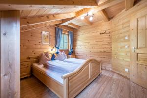 a bedroom in a log cabin with a bed in it at Ferienhaus Pichlerhof in Fundres