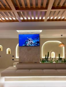 a lobby with a television on a wall at Coral Boutique Hotel in Vlorë