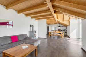 a living room with a couch and a table at Cosy Home Allgäu in Haldenwang