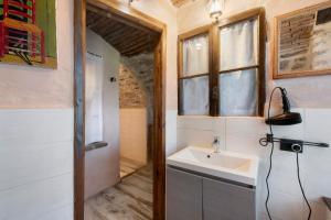 a bathroom with a sink and a window at Casale La Selva Cottege piccolo in Piano Porlezza