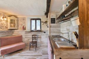 a kitchen with a sink and a counter top at Casale La Selva Cottege piccolo in Piano Porlezza