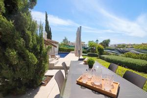 a table with wine glasses on it on a patio at Sweet Home Albufeira in Albufeira