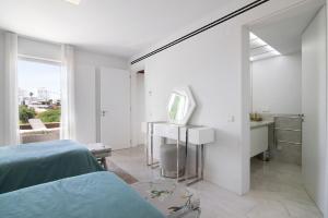 a white bedroom with a bed and a mirror at Sweet Home Albufeira in Albufeira +31 photos