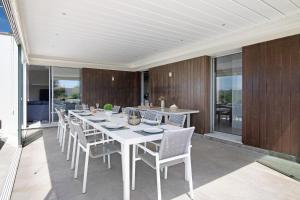 a dining room with a white table and chairs at Sweet Home Albufeira in Albufeira