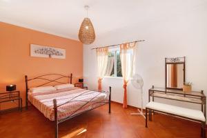 a bedroom with a bed and a mirror and a window at Casa Palma in Paderne +24 photos