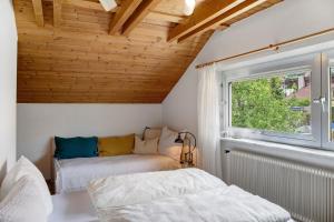 two beds in a room with a window at Haus Gutschi in Imst